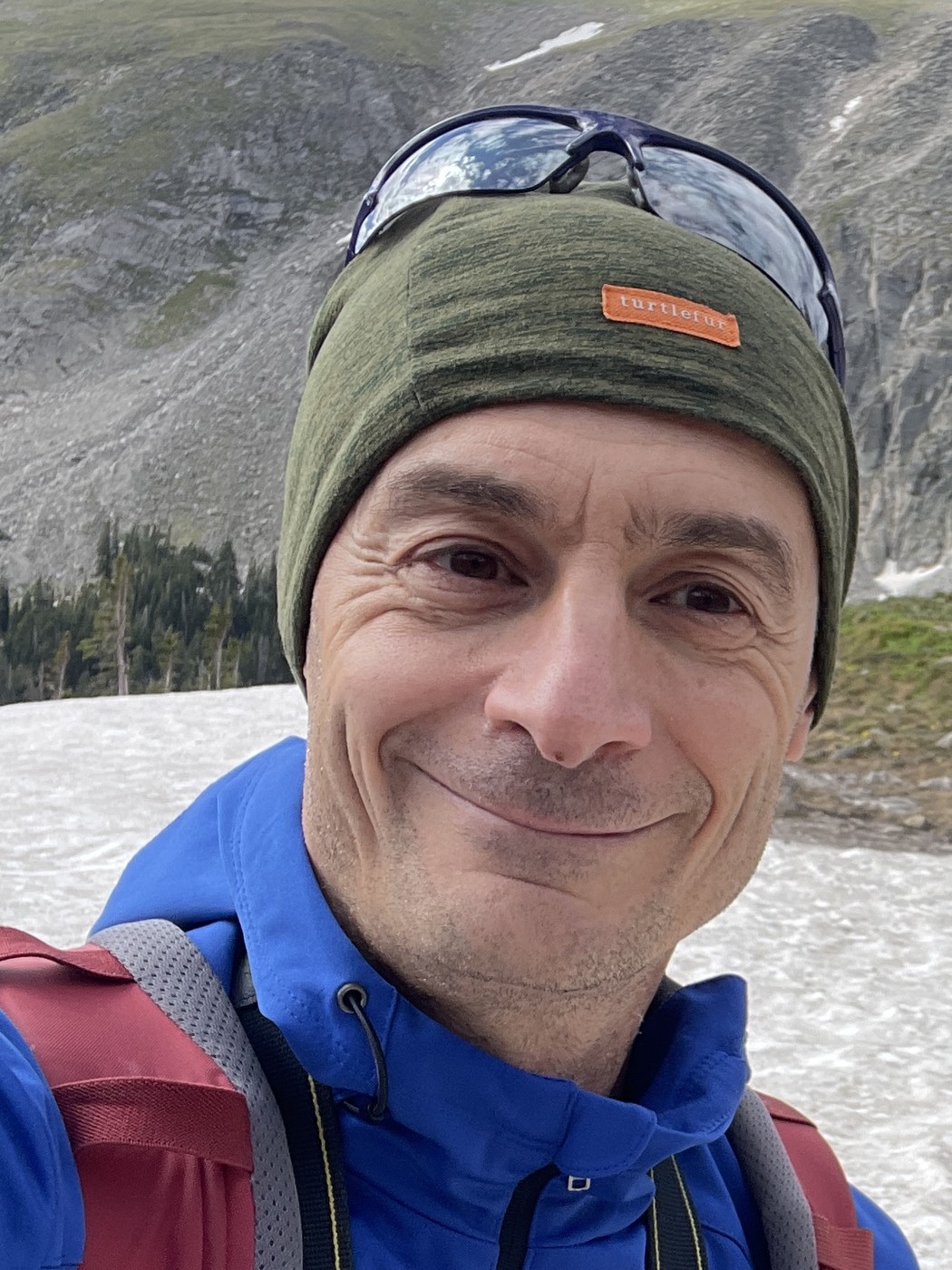 Enrico, Associate Broker at Rex Homes, on a snowfield in the Colorado high country